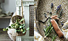 Hand arrangerar blommor och gröna kvistar i en flätad korg med dekorativa detaljer.
