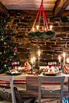 krans av granris över ett dukat bord i juletid
